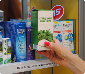 Hand selecting medicine from pharmacy shelves