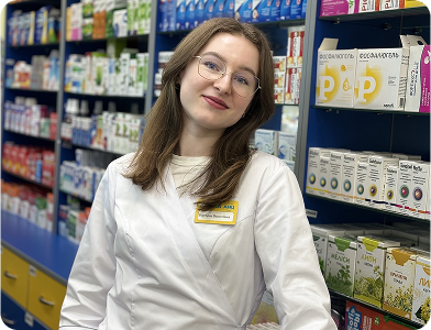 ANC pharmacist with glasses among medicine shelves